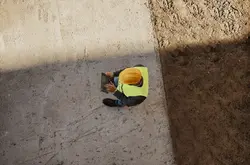 Bird view of a construction worker on tablet device outdoors.