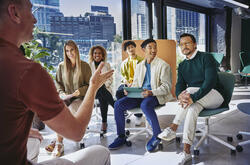 Group of people having a meeting, in a room with glass windows