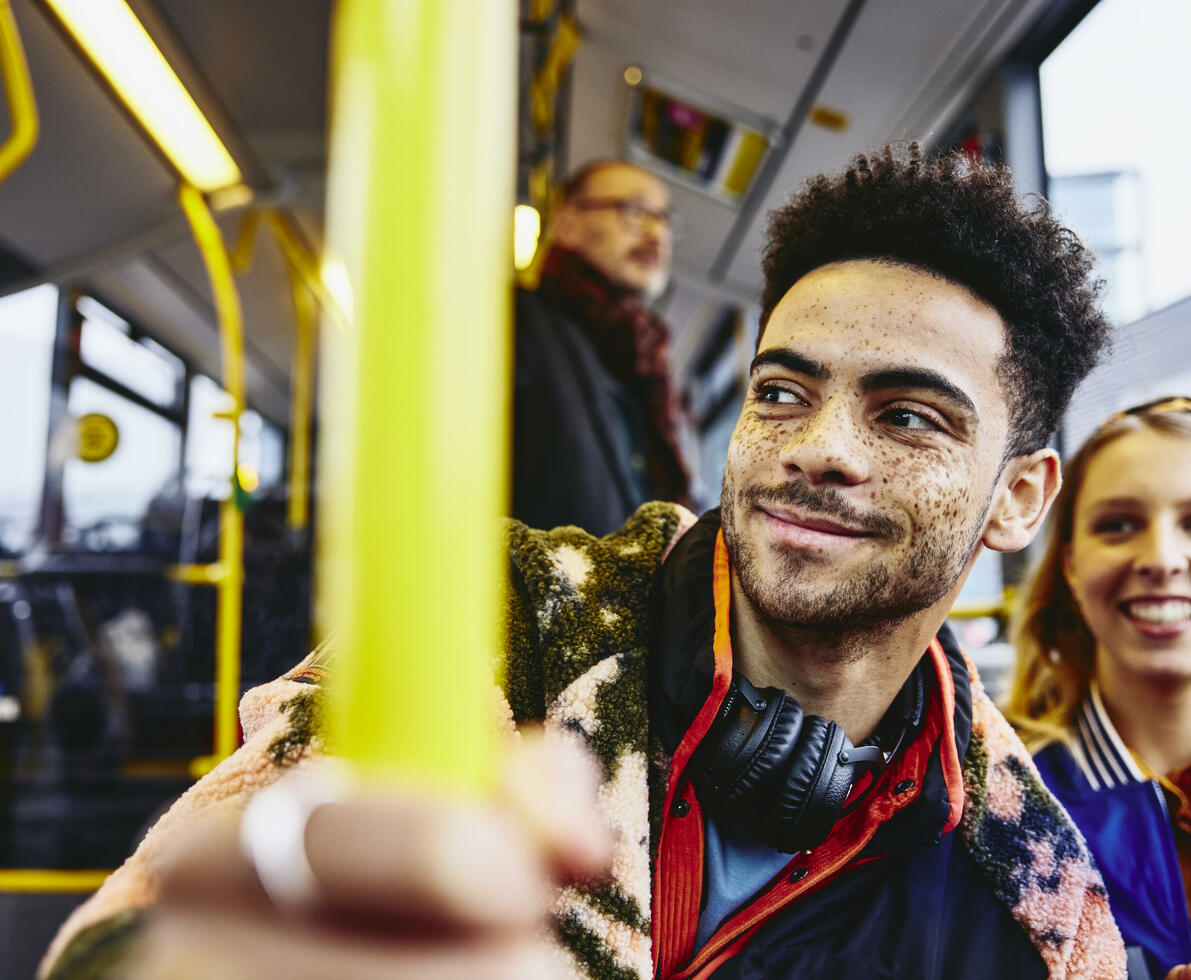 Womale and boy smiling, sitting in a bus.
Womale and boy smiling, sitting in a bus.